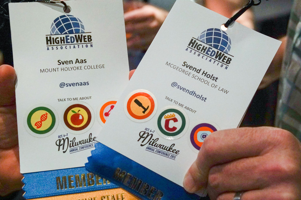 Attendees show their conference lanyards
